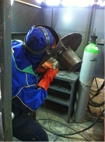 A welder performing a test on an assigned test piece